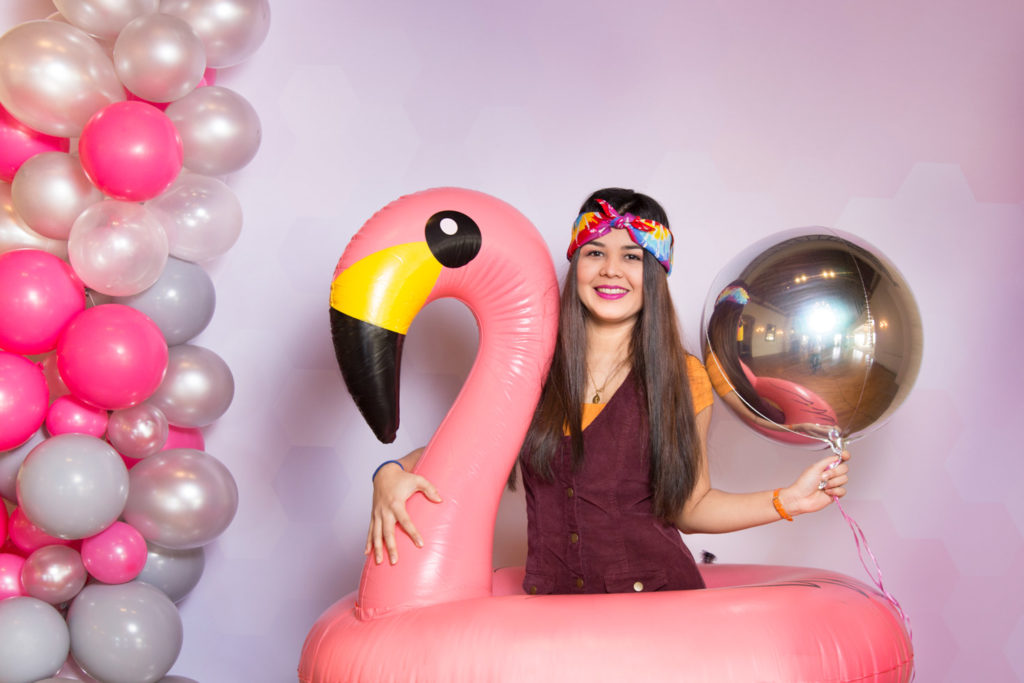 Laura inside a flamingo with that cool backdrops and beautiful balloons