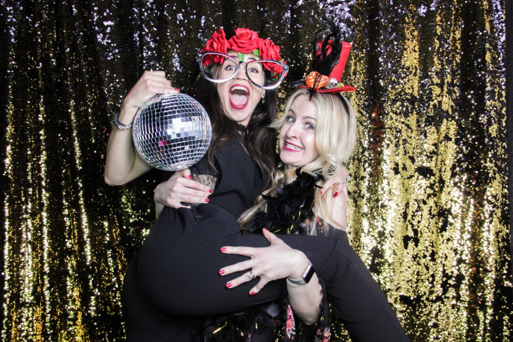 jumping on your girlfriends arms with a disco ball for the photo booth photo