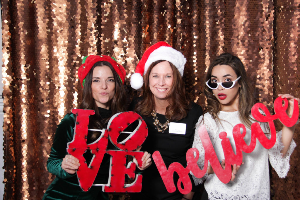 small business owners posing with beautiful holiday props