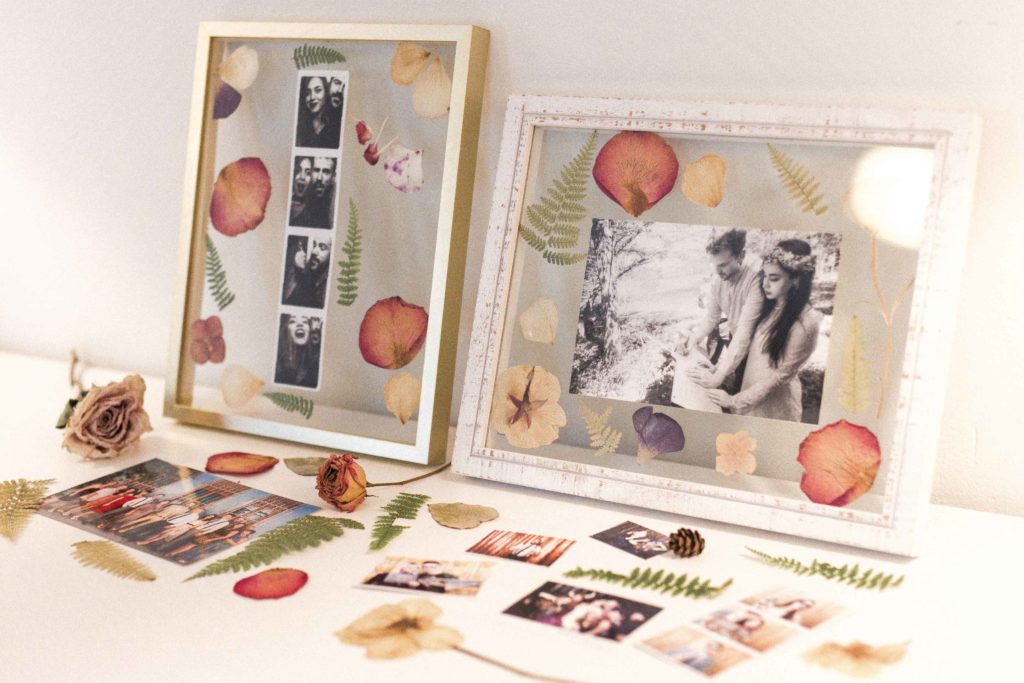 stylisg photo frame with pressed flowers and a wedding photo and a photo booth photo
