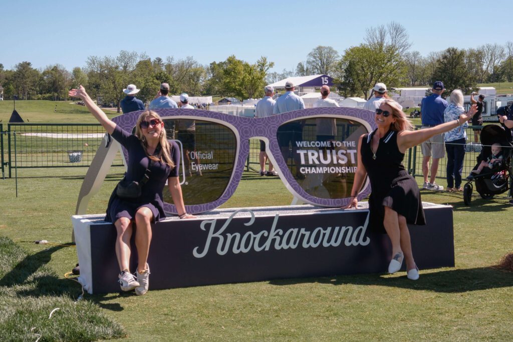 women happily posing in front of a huge pair of sunglasses for a selfie booth brand activation
